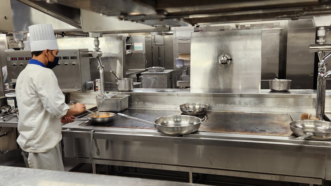 a-chef-cooking-in-a-kitchen-25dgbmq-kpi