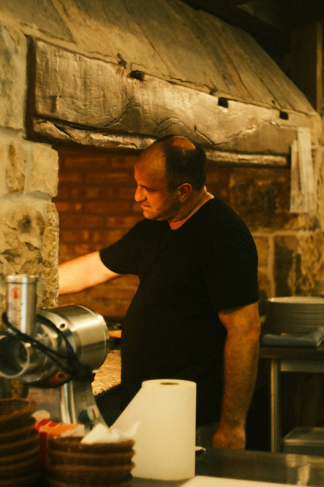 man-working-in-a-rustic-kitchen-with-meat-grinder-yq8xqjrz6sc